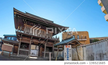 Tokyo. Iōji Temple in Katsushika Shibamata, with its imposing Niomon gate and blue sky. Tokyo. Iōji Temple in Katsushika Shibamata, with its imposing Niomon gate and blue sky. 139321685