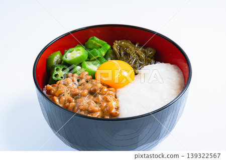 Sticky Rice Bowl: Rice topped with natto, okra, grated yam, mekabu seaweed, and egg yolk (on a white background) 139322567