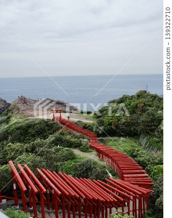 A red torii gate leading to the sea A red torii gate leading to the sea 139322710
