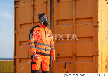 Caucasian Male Technician Putting on Gas Mask at Industrial Site for Hazardous Material Safety Europe Caucasian Male Technician Putting on Gas Mask at Industrial Site for Hazardous Material Safety Europe 139323101
