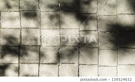 Square wooden block pavement with soft tree shadows, suitable for architectural or design projects. Square wooden block pavement with soft tree shadows, suitable for architectural or design projects. 139324632