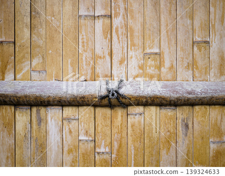 Close up texture of vertically aligned bamboo wall, showcasing natural pattern, suitable for sustainability focused content. Close up texture of vertically aligned bamboo wall, showcasing natural pattern, suitable for sustainability focused content. 139324633