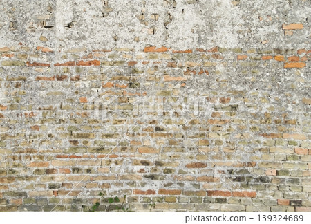 Old weathered brick wall background providing a textured architectural surface suitable for design and background use. Old weathered brick wall background providing a textured architectural surface suitable for design and background use. 139324689