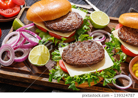 beef cheeseburgers with brioche buns on a tray 139324787