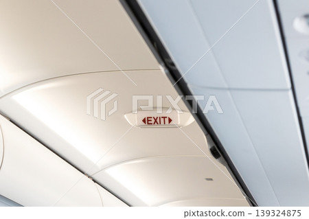 Emergency exit sign inside airplane cabin Emergency exit sign inside airplane cabin 139324875