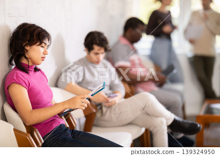 Young girl applicant sitting in a queue at a modern office 139324950