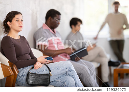 People are sitting in line and waiting for an interview People are sitting in line and waiting for an interview 139324975