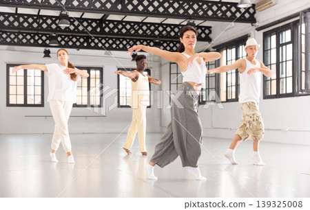 People practicing vigorous lindy hop movements in dance class People practicing vigorous lindy hop movements in dance class 139325008
