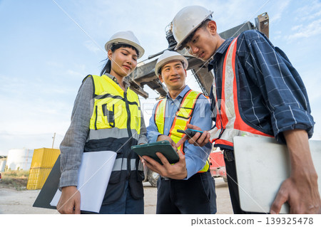 Asian Shipping Supervisors Reviewing Cargo Data on Tablet at Thailand Logistics Port Site 139325478
