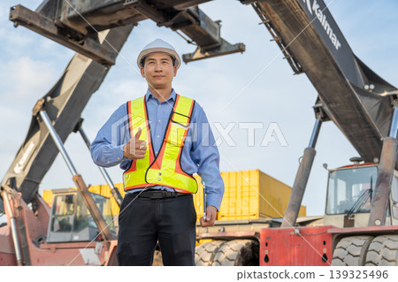 Successful Asian Logistics Manager Giving Thumbs Up at Thailand Container Port Site Successful Asian Logistics Manager Giving Thumbs Up at Thailand Container Port Site 139325496