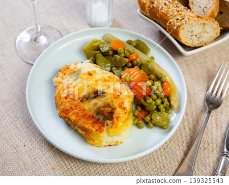 Fried cod fish garnished with vegetable ragout Fried cod fish garnished with vegetable ragout 139325543