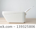 White office printer with a stack of blank A4 paper loaded in the feeder tray, shown in a clean minimalist workspace. Conceptual image for printing, office equipment, productivity and documentation. 139325806