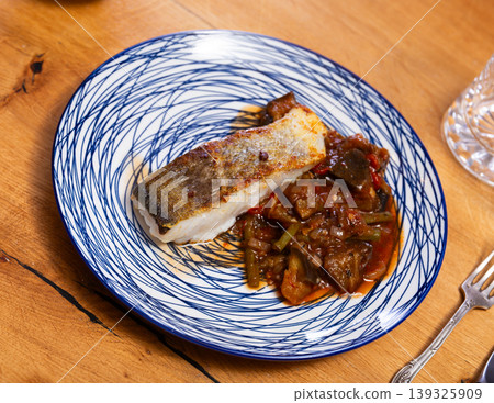 Fried cod fish garnished with vegetable ragout 139325909