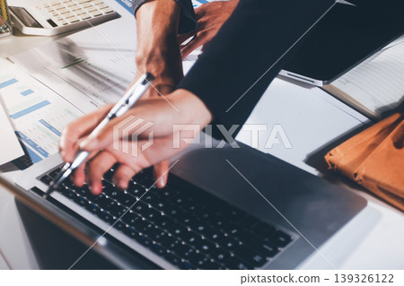 Professional photo of a person's hands reviewing a contract or legal document on a desk, for concepts of business, finance, and legal affairs Professional photo of a person's hands reviewing a contract or legal document on a desk, for concepts of business, finance, and legal affairs 139326122