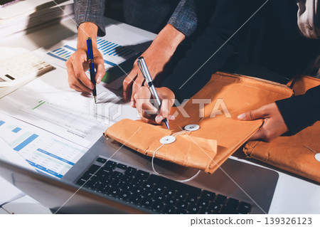 Professional photo of a person's hands reviewing a contract or legal document on a desk, for concepts of business, finance, and legal affairs Professional photo of a person's hands reviewing a contract or legal document on a desk, for concepts of business, finance, and legal affairs 139326123