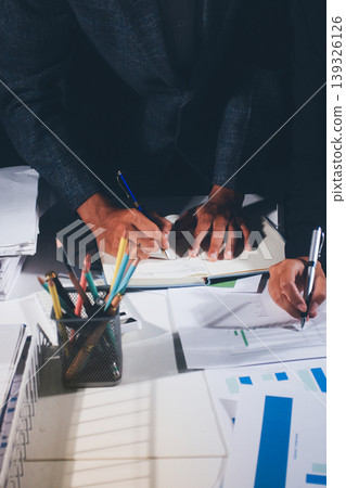 Professional photo of a person's hands reviewing a contract or legal document on a desk, for concepts of business, finance, and legal affairs Professional photo of a person's hands reviewing a contract or legal document on a desk, for concepts of business, finance, and legal affairs 139326126