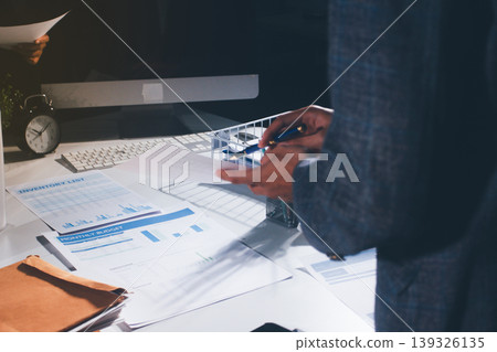 Professional photo of a person's hands reviewing a contract or legal document on a desk, for concepts of business, finance, and legal affairs Professional photo of a person's hands reviewing a contract or legal document on a desk, for concepts of business, finance, and legal affairs 139326135