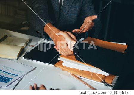Professional photo of a person's hands reviewing a contract or legal document on a desk, for concepts of business, finance, and legal affairs Professional photo of a person's hands reviewing a contract or legal document on a desk, for concepts of business, finance, and legal affairs 139326151