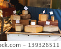 Artisan Cheese Display at Market Stall with Various Cheese Wheels 139326511