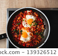 Top View of Shakshuka with Eggs in Cast Iron Pan 139326512