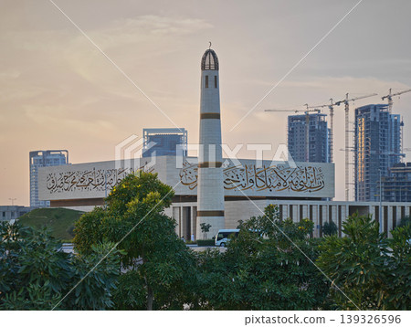 Qetaifan Island North, Lusail Qatar-February 12 2026: Majra Al Sail Park in Lusail offers canal views and lush gardens. Mosque Twenty Seven in background     139326596