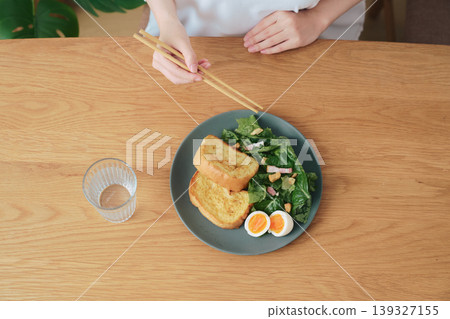 A simple breakfast plate: toast, salad, and a boiled egg. A simple breakfast plate: toast, salad, and a boiled egg. 139327155