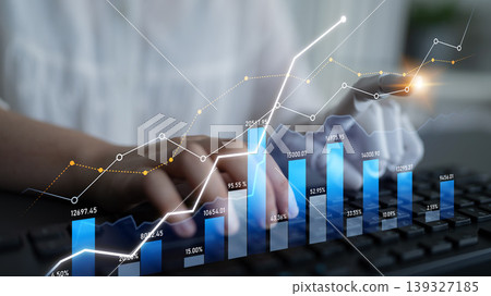 Business analytics with hands on keyboard and digital chart trends displaying growth and performance metrics in modern office environment for stock market analysis Scalp Business analytics with hands on keyboard and digital chart trends displaying growth and performance metrics in modern office environment for stock market analysis Scalp 139327185