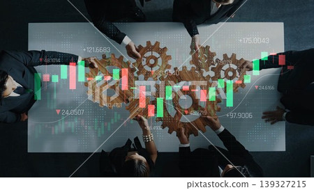 A group of business professionals collaborates over a transparent table with gear visuals and stock market graphs, symbolizing teamwork and strategic financial planning. Sigmoid A group of business professionals collaborates over a transparent table with gear visuals and stock market graphs, symbolizing teamwork and strategic financial planning. Sigmoid 139327215