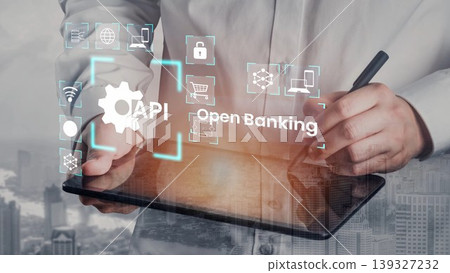 Businessman Using Tablet to Explore Open Banking Solutions with API Integration and Digital Icons Representing Financial Services Gluon Businessman Using Tablet to Explore Open Banking Solutions with API Integration and Digital Icons Representing Financial Services Gluon 139327232