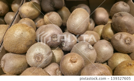 Many ripe yellow pears carefully packed in a crate with individual green paper liners. Focus on quality control and fresh produce retail Many ripe yellow pears carefully packed in a crate with individual green paper liners. Focus on quality control and fresh produce retail 139327605