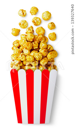 Caramel popcorn spilled out of the box on a white background. Top view Caramel popcorn spilled out of the box on a white background. Top view 139327640