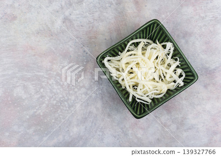 Dried squid in bowl, minimal food composition. 139327766