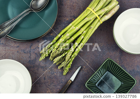 Raw green asparagus bunch on light kitchen background Raw green asparagus bunch on light kitchen background 139327786