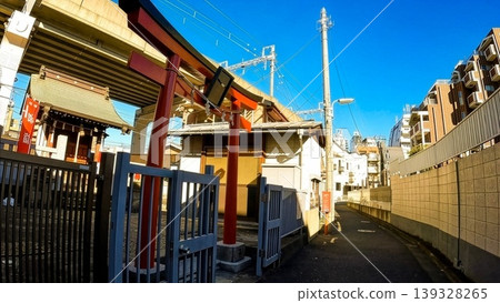 The torii gate and shrine building of Seiun Inari Shrine, located along the railway tracks in Tokyo. The torii gate and shrine building of Seiun Inari Shrine, located along the railway tracks in Tokyo. 139328265