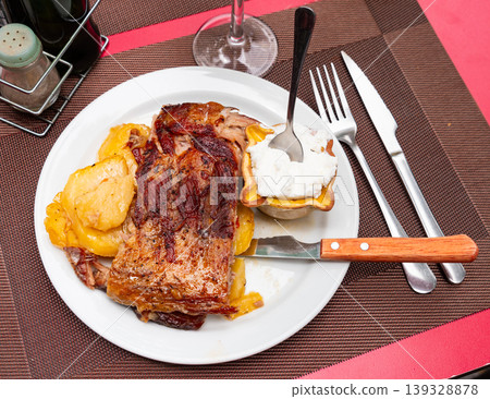 Fried or baked pork ribs are garnished with potato slices Fried or baked pork ribs are garnished with potato slices 139328878