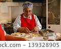 Senior Black Woman Chef Preparing Savory Pies in Professional Commercial Kitchen Setting 139328905