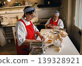 Senior Caucasian and Hispanic women baking pastries in a professional kitchen setting 139328921