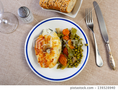 Fried cod fish garnished with vegetable ragout Fried cod fish garnished with vegetable ragout 139328940