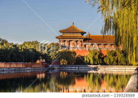 Sunrise view of Forbidden City watch tower next to surrounding scenic moat to ensure security of the palace. 139328989