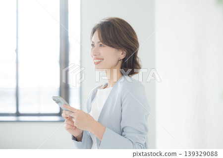 A woman watching a smartphone A woman watching a smartphone 139329088