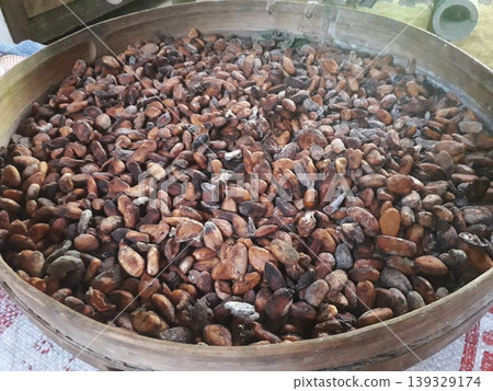 Dried Raw Cocoa Beans in Traditional Bamboo Tray Inside a House Dried Raw Cocoa Beans in Traditional Bamboo Tray Inside a House 139329174