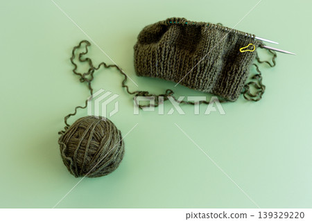 handmade knitting project with yarn ball and knitting needles handmade knitting project with yarn ball and knitting needles 139329220