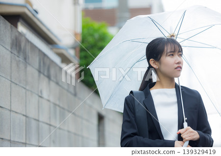 Business woman pointing an umbrella Business woman pointing an umbrella 139329419