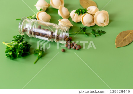 traditional dumplings with spices on a green background 139329449