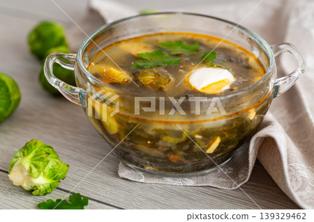 hot green sorrel soup with Brussels sprouts on a wooden table hot green sorrel soup with Brussels sprouts on a wooden table 139329462