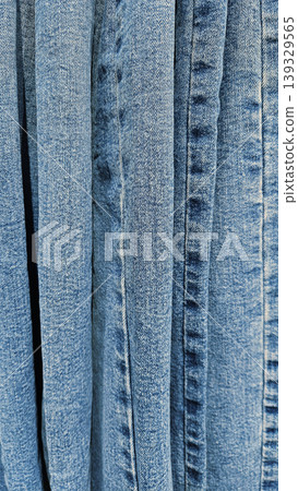 Denim background of many blue jeans 139329565