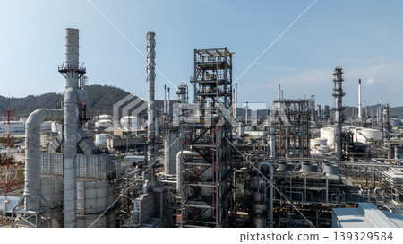 Oil storage tank with oil refinery plant background, Global business power and energy chemical barrel, Oil refinery factory oil storage tank, Petrochemical industrial with blue sky. 139329584