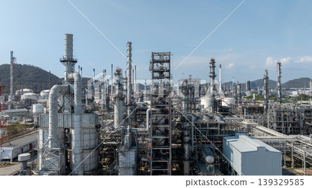 Oil storage tank with oil refinery plant background, Global business power and energy chemical barrel, Oil refinery factory oil storage tank, Petrochemical industrial with blue sky. Oil storage tank with oil refinery plant background, Global business power and energy chemical barrel, Oil refinery factory oil storage tank, Petrochemical industrial with blue sky. 139329585
