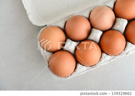 Top view of brown raw eggs in a cardboard carton Top view of brown raw eggs in a cardboard carton 139329662