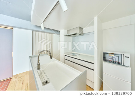The interior features a kitchen with a white color scheme. The interior features a kitchen with a white color scheme. 139329700